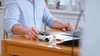 Car design engineer working on car prototype for automobile business at home office. Automotive...