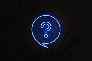 Blue neon sign with speech bubble and question mark