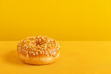 caramel glazed donut in yellow surface close up