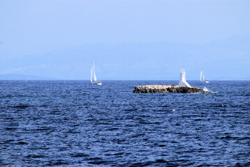 small island with lighthouse near Vis, the island Vis, Croatia