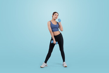 Vigorous energetic woman doing dumbbell weight lifting exercise on isolated background. Young athletic asian woman strength and endurance training session as body workout routine.