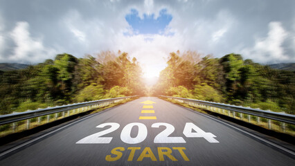 New year 2024 or straight forward concept. Text START 2024 with arrow symbol  written on the road in the middle of asphalt road with at sunset. Goals, Plans and Visions. Business target, challenge.