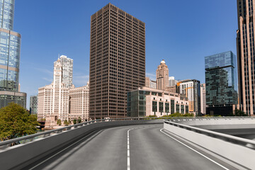 Fototapeta premium Empty urban asphalt road exterior with city buildings background. New modern highway concrete construction. Concept of way to success. Transportation logistic industry fast delivery. Chicago. USA.