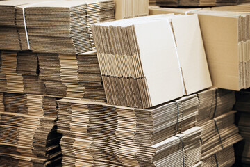 Folded cardboard boxes. Shipping background. Pile of cartons. Stacked cardboard paper boxes.