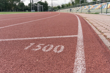 Ground-level shot of an athletics track at its 1,500-meter distance mark.