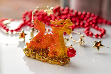 Fire Dragon symbol of year 2024. Dragon holding pearl. Figurine-mascot Chinese Dragon. Christmas decorations