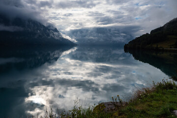 Clouds rolling in above fhord in Norway during summer