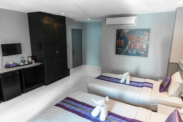 Hotel Room Decorated single double bedroom with nice white bed sheets purple decorative colours. the colour scheme is designed for thailand and interior is m modern classical