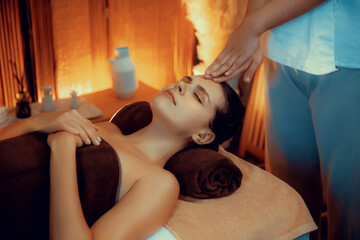 Caucasian woman enjoying relaxing anti-stress head massage and pampering facial beauty skin...