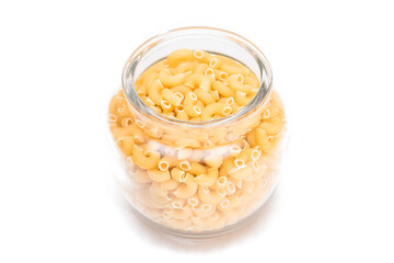 Uncooked Chifferi Rigati Pasta in Glass Jar Isolated on White Background. Fat and Unhealthy Food. Classic Dry Macaroni. Italian Culture and Cuisine. Raw Pasta - Isolation