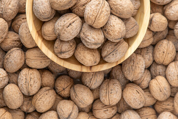 Walnut in shell. Background view from above. Healthy food bowl top view
