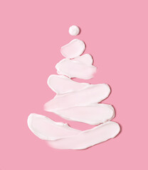 The concept of a Christmas tree in the form of cosmetic strokes on a pink background. Christmas...