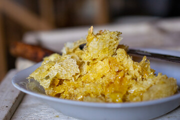 Cut tops of honeycombs with honey