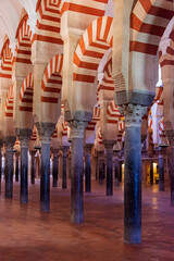 Striped arches and marble pillars in the prayer room of the cathedral mosque of Cordoba, Andalusia.