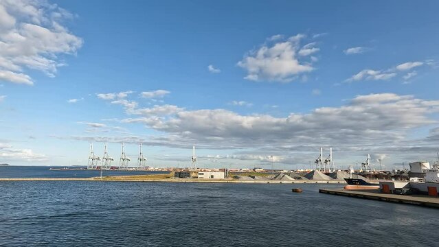Sky and clouds. Timelapse. Seaport. Timelapse shot of the harbour area with boats and cranes. Blue sky white clouds. Summer blue sky Nature weather blue sky. Cloud time lapse nature background.