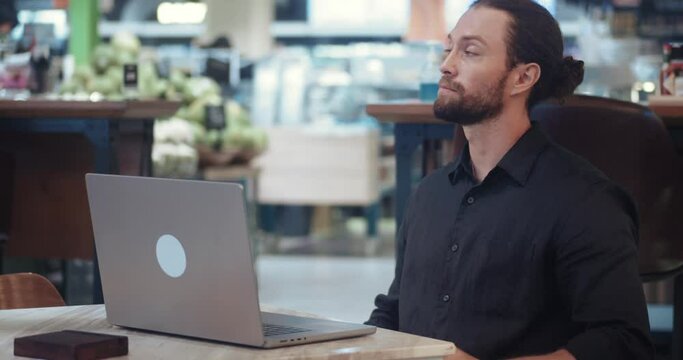 Relationship problems or negative experiences communicating with others via the Internet or social platforms. Man sits in a cafe at a computer and scrolls a dating site concept relationship problems