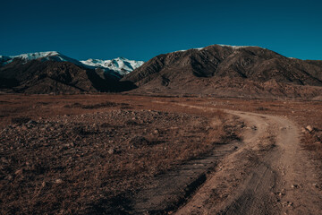 Autumn mountain landscape with dirt road in Asia