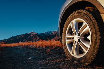 Car wheel offroad closeup view at twilight