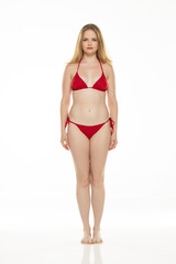 Obraz premium Full body, front view young blond woman in bikini posing on white background