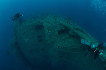A group of divers swimming above the hull of the sunken MV Salem Express Marsa Alam, Egypt