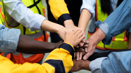 group of multiracial colleagues joining hands in morning meeting before going to work at a...