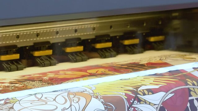 Large Inkjet printer working, industrial printer, plotter head slides over the surface of the paper and prints a large image.