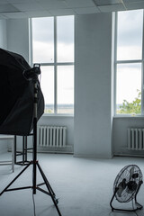 Photo studio in natural daylight with soft box, fan