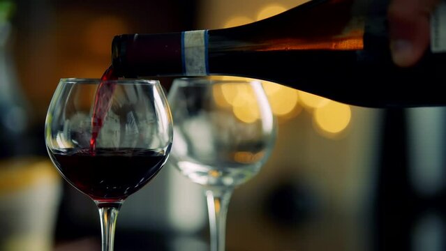 Red wine poured into wine glass in restaurant	