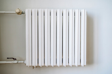 Heating radiator in the interior of an apartment or house during the cold winter heating period