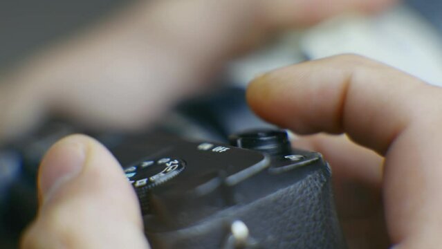 photographer takes picture by pressing button on digital camera 