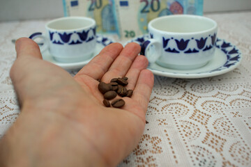 grains of coffee in the hand of a middle aged male