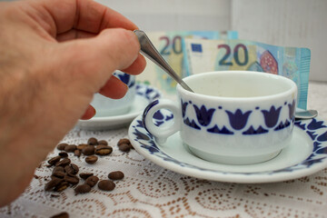 stirring the coffee and euro bills in the background