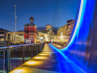 Waterfront suspension bridge and clock tower lit up at night, Cape Town, South Africa