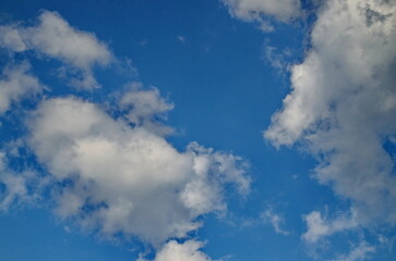 Background of rainy fluffy clouds floating on a bright blue sky, Sofia, Bulgaria 