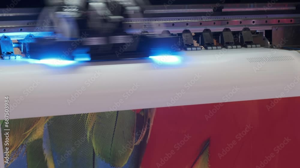 Poster large inkjet printer working, industrial printer, plotter head slides over the surface of the paper 