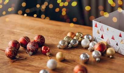 New Year's balls on a wooden table against a background of bokeh lights