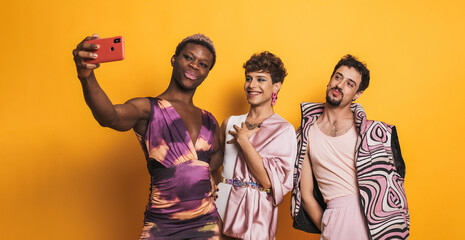 Multiethnic trans men taking a selfie in a photographic studio - obrazy, fototapety, plakaty