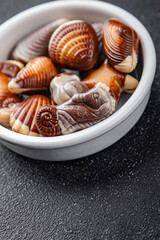 candy seashells chocolate sweet dessert eating cooking appetizer meal food snack on the table copy space food background rustic top view