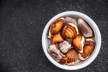 candy seashells chocolate sweet dessert eating cooking appetizer meal food snack on the table copy...