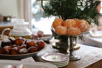 
vase with peeled tangerines on a table decorated for Christmas