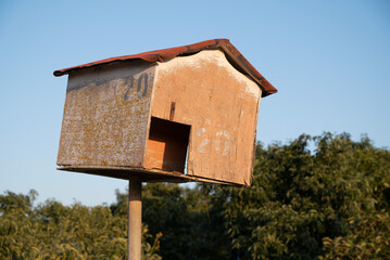 Biological pest control: Man made birdhouse, designed for The Barn Owl (Tyto alba), mounted on a pole in an avocado orchard 