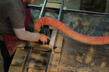 Skilled hands at a saw. The image reflects the enduring value of skilled manual work.