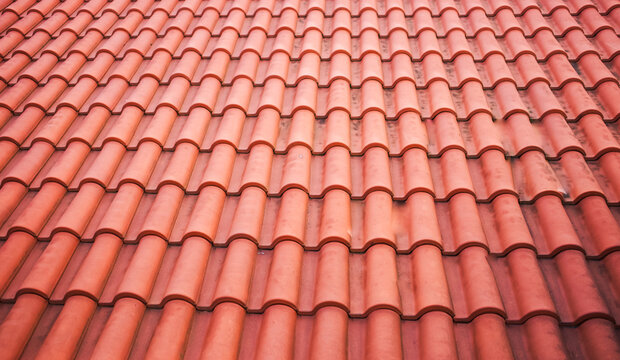 Spanish Tiles for roof. Red roof tiles on house as background image. Shingles roofing surface tiles overlay pattern