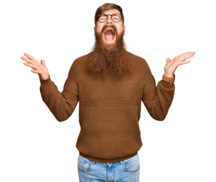 Young irish redhead man wearing casual clothes and glasses celebrating mad and crazy for success with arms raised and closed eyes screaming excited. winner concept