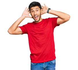 Young handsome man wearing casual red tshirt smiling cheerful playing peek a boo with hands showing face. surprised and exited
