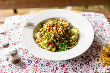 Healthy salad with olive oil and beautiful natural ambience Top view