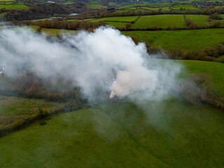 Fototapeta na wymiar Fire in a field causing massive air pollution 