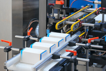Automatic packaging conveyor line in pharmaceutical factory, pharmaceutical industrial concept background