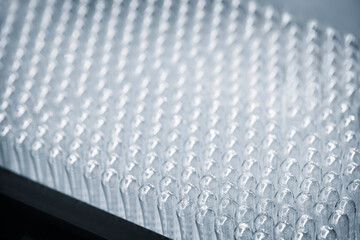 Fototapeta premium Vaccine production in a pharmaceutical factory, conveyor with the glass jars, modern pharmaceutical factory. Closeup of ampules are being filled with vaccine