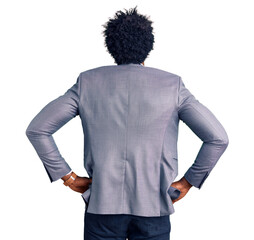 Handsome african american man with afro hair wearing business jacket standing backwards looking away with arms on body